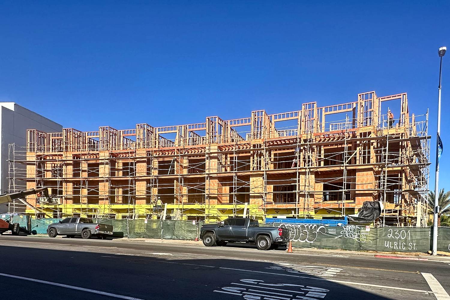 Street-level view of Ulric Street multifamily mid-rise wood framing
