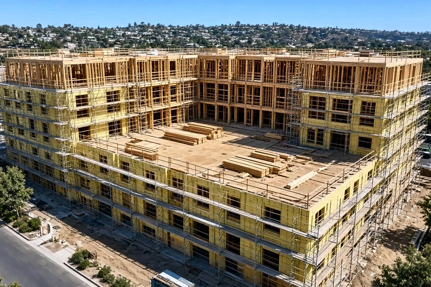 Aerial of large multifamily courtyard podium wood framing