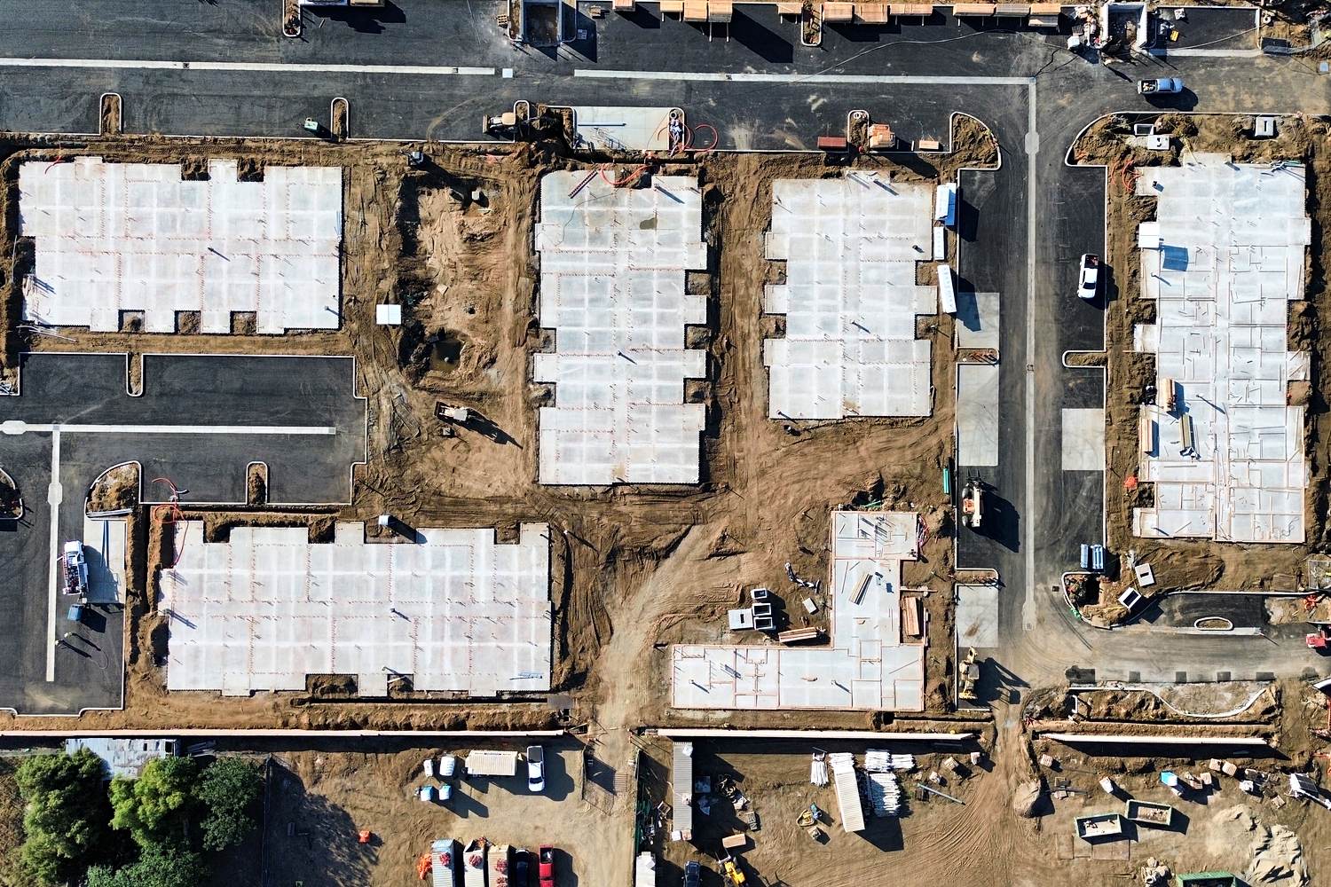 Aerial of multi-building concrete foundations ready for framing