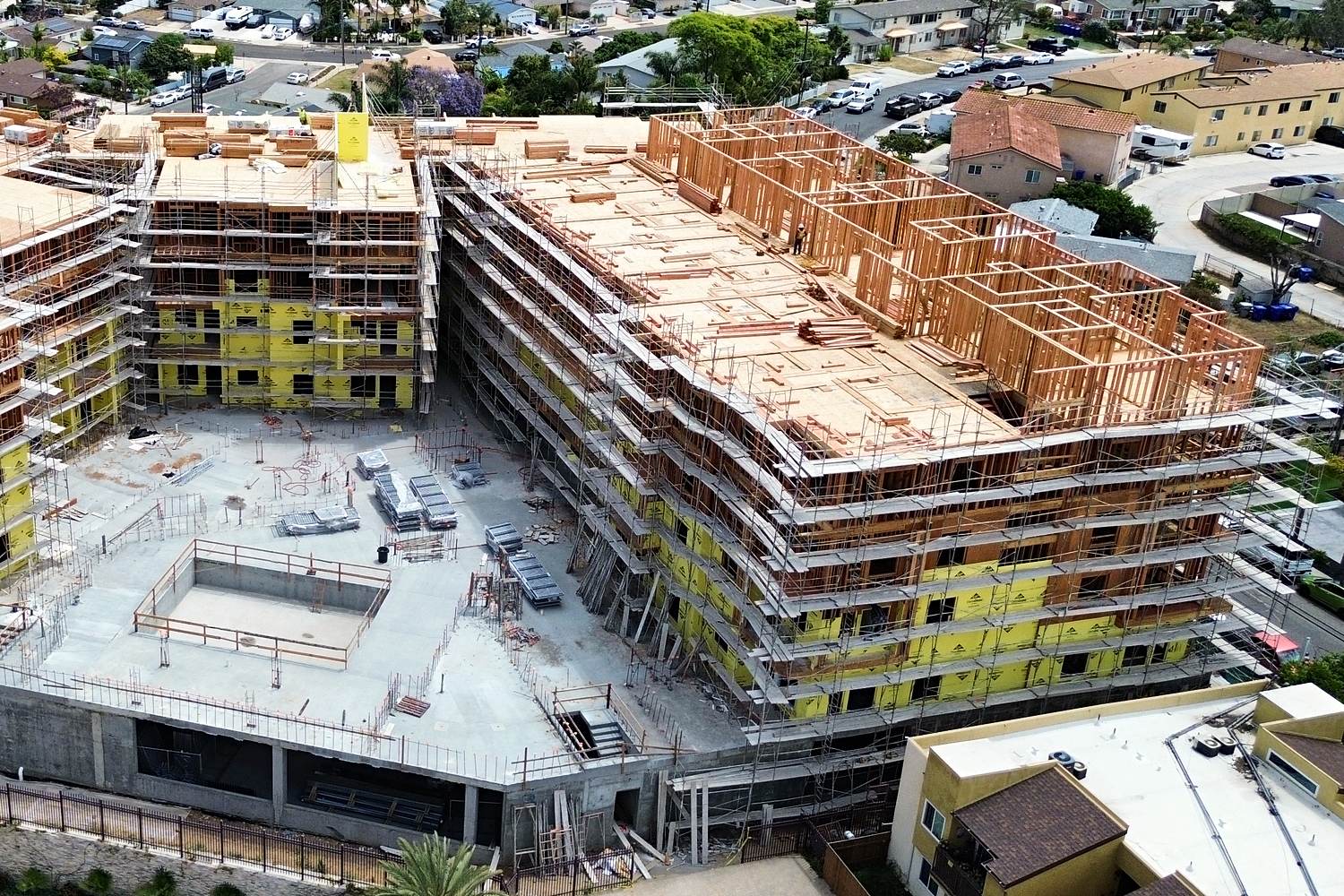 Aerial courtyard view of podium multifamily framing