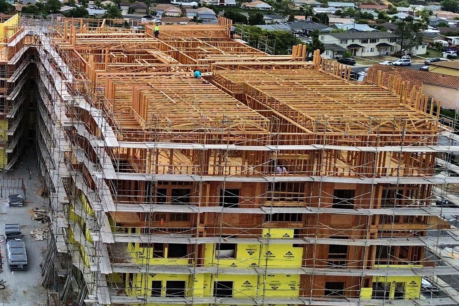 Aerial of U-shaped mid-rise framing under overcast sky