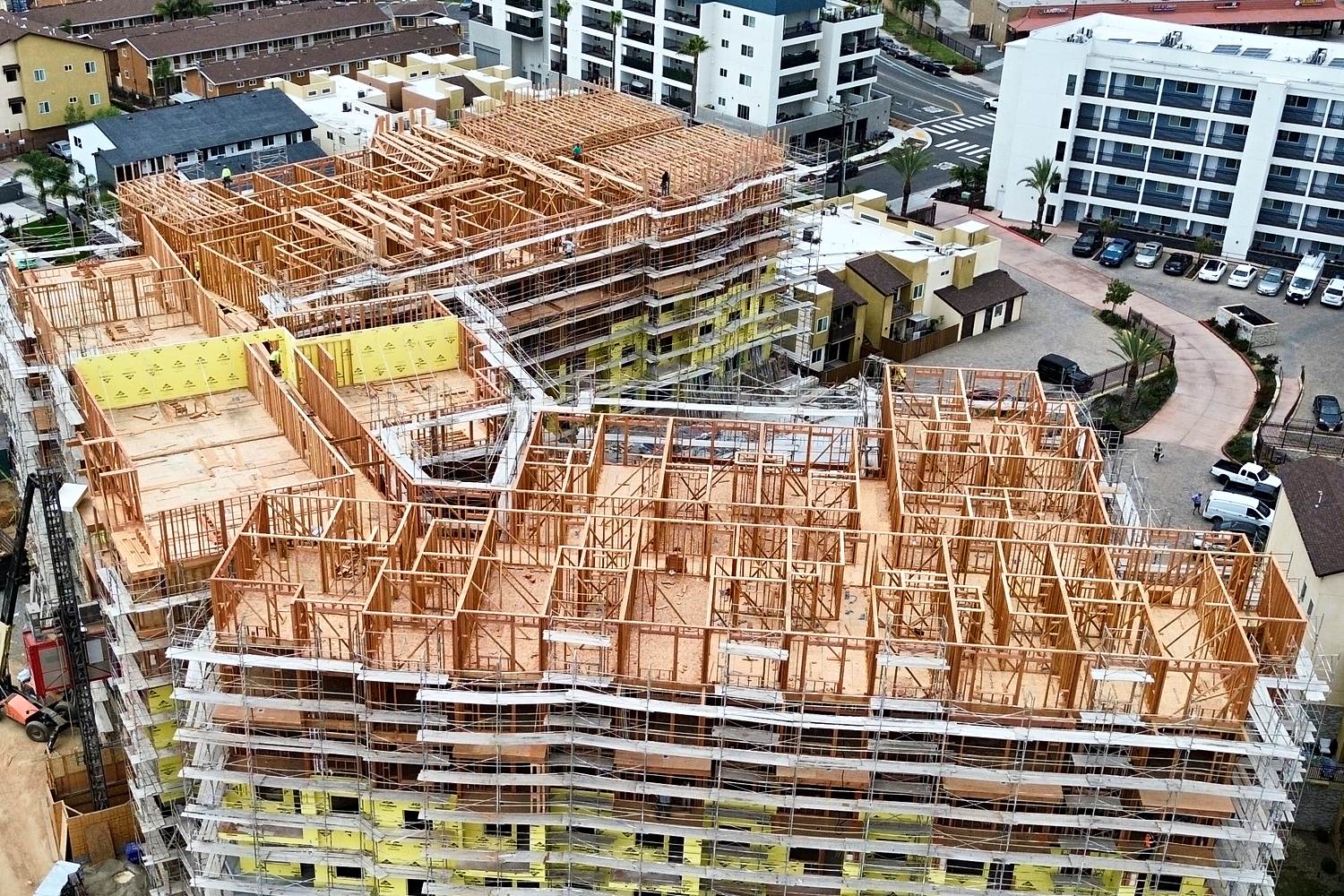 Aerial of irregular mid-rise multifamily framing