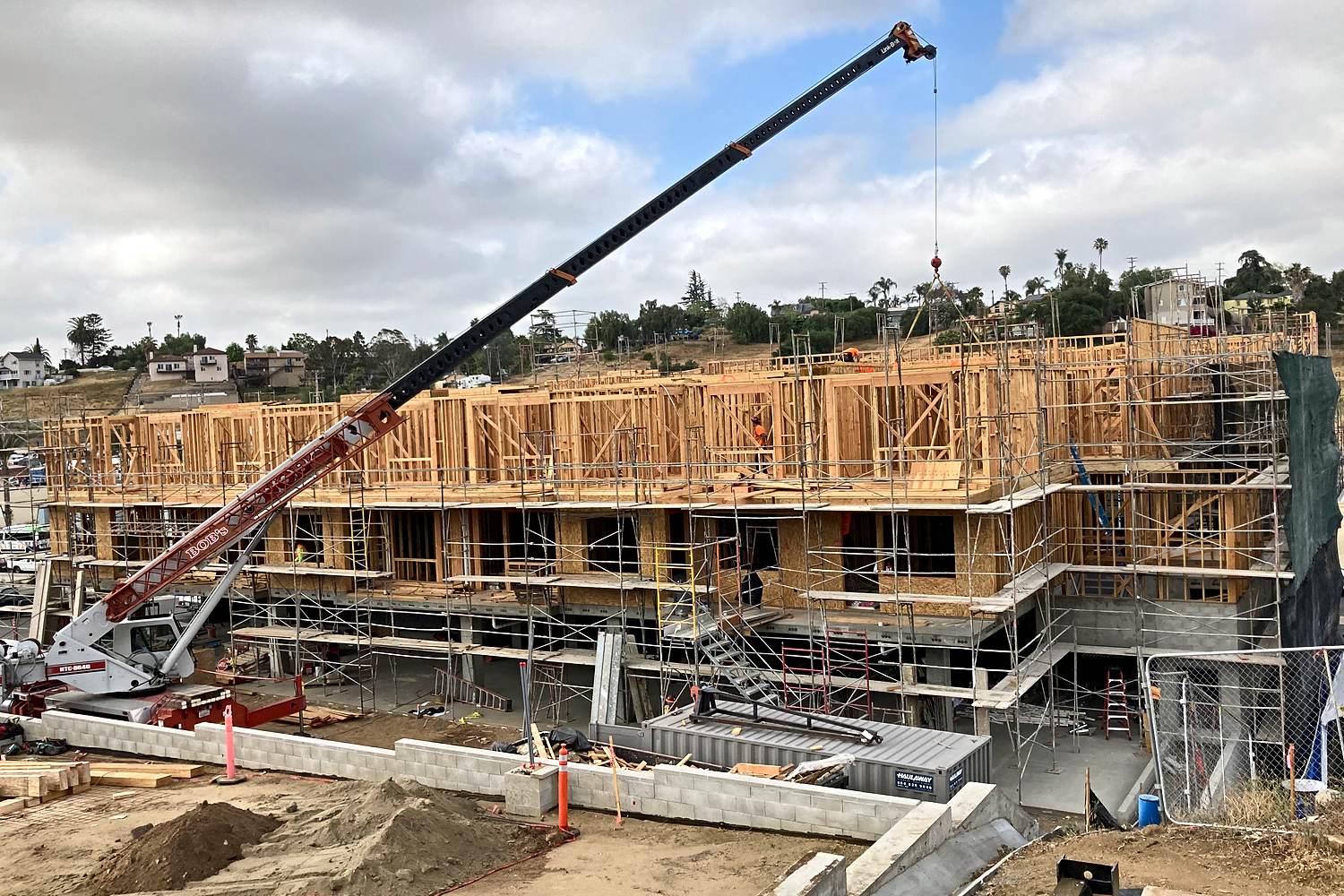Podium multifamily framing with mobile crane on site