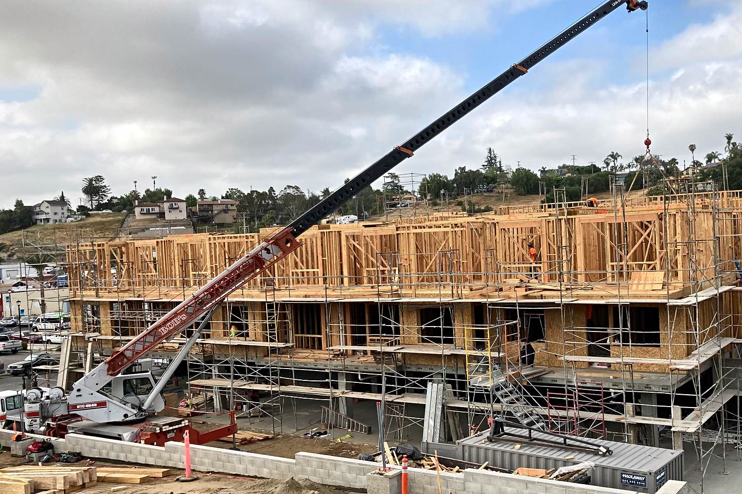 Podium multifamily framing with crane boom extended